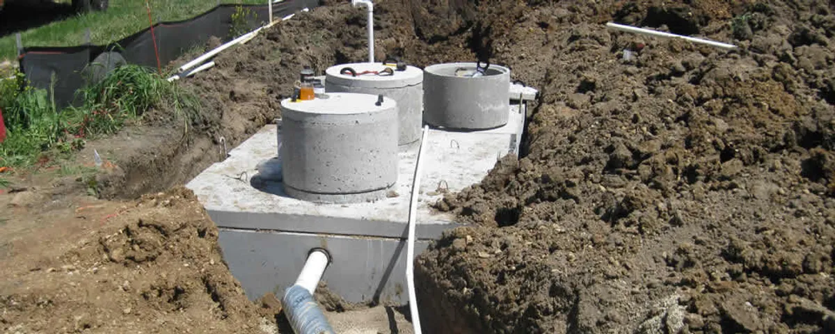 Septic system repair and installation site with tank access ports in Norton, MA